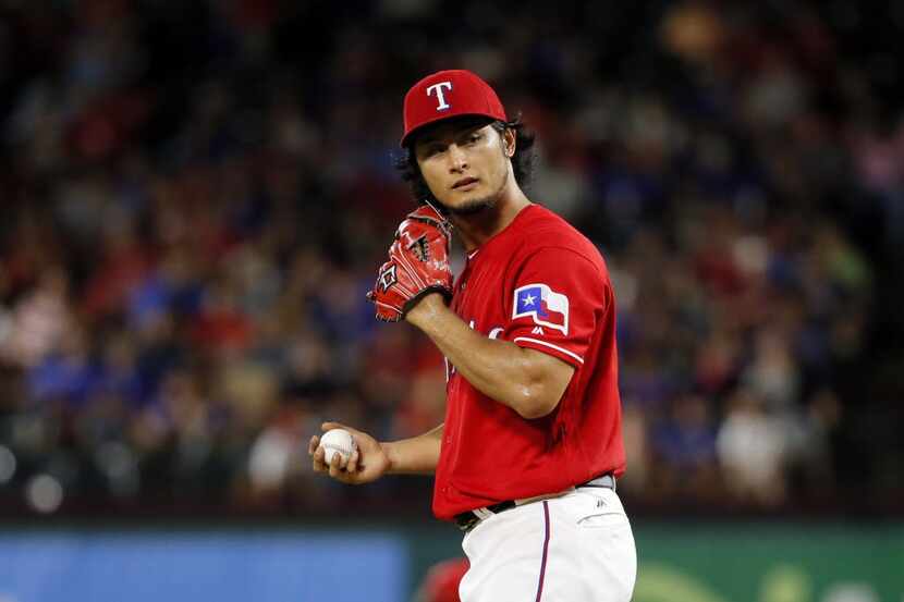 Texas Rangers' Yu Darvish of Japan looks to the plate before throwing to the Oakland...