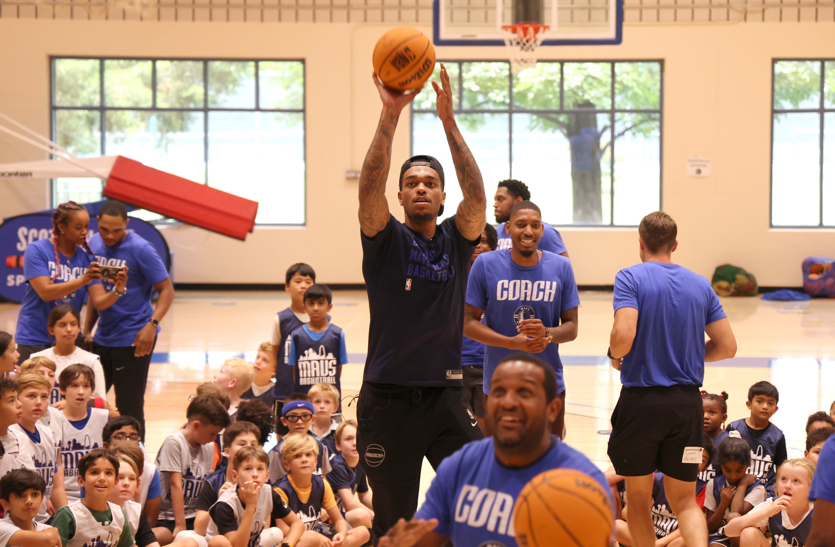 Dallas Mavericks forward and center PJ Washington puts up a shot under the watchful eye of...