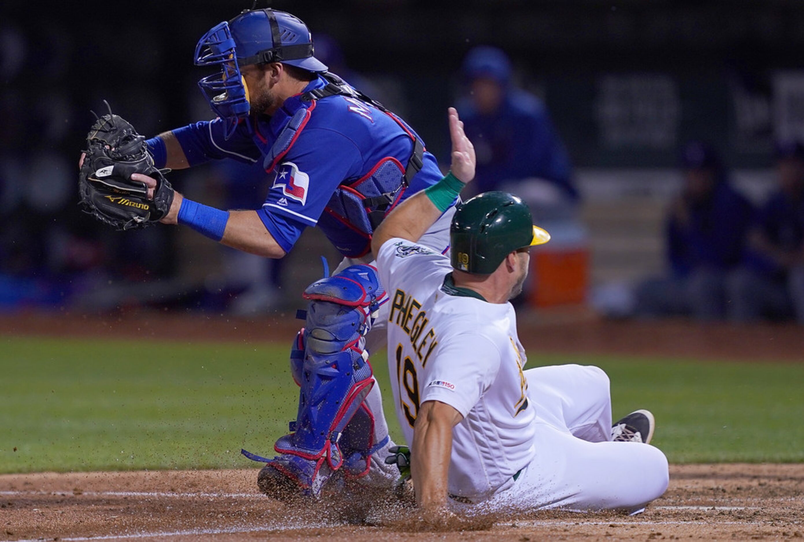 OAKLAND, CA - APRIL 22:  Josh Phegley #19 of the Oakland Athletics scores on a sacrifice fly...