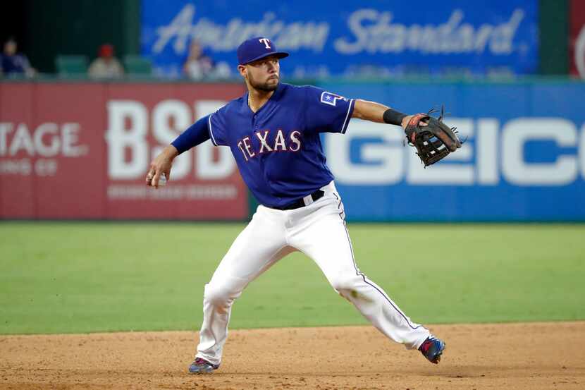 Texas Rangers third baseman Isiah Kiner-Falefa (9) throws to first during a baseball game...