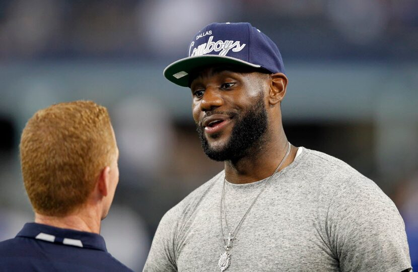 Cowboys head coach Jason Garrett talks with  Lebron James before a game between the Cowboys...