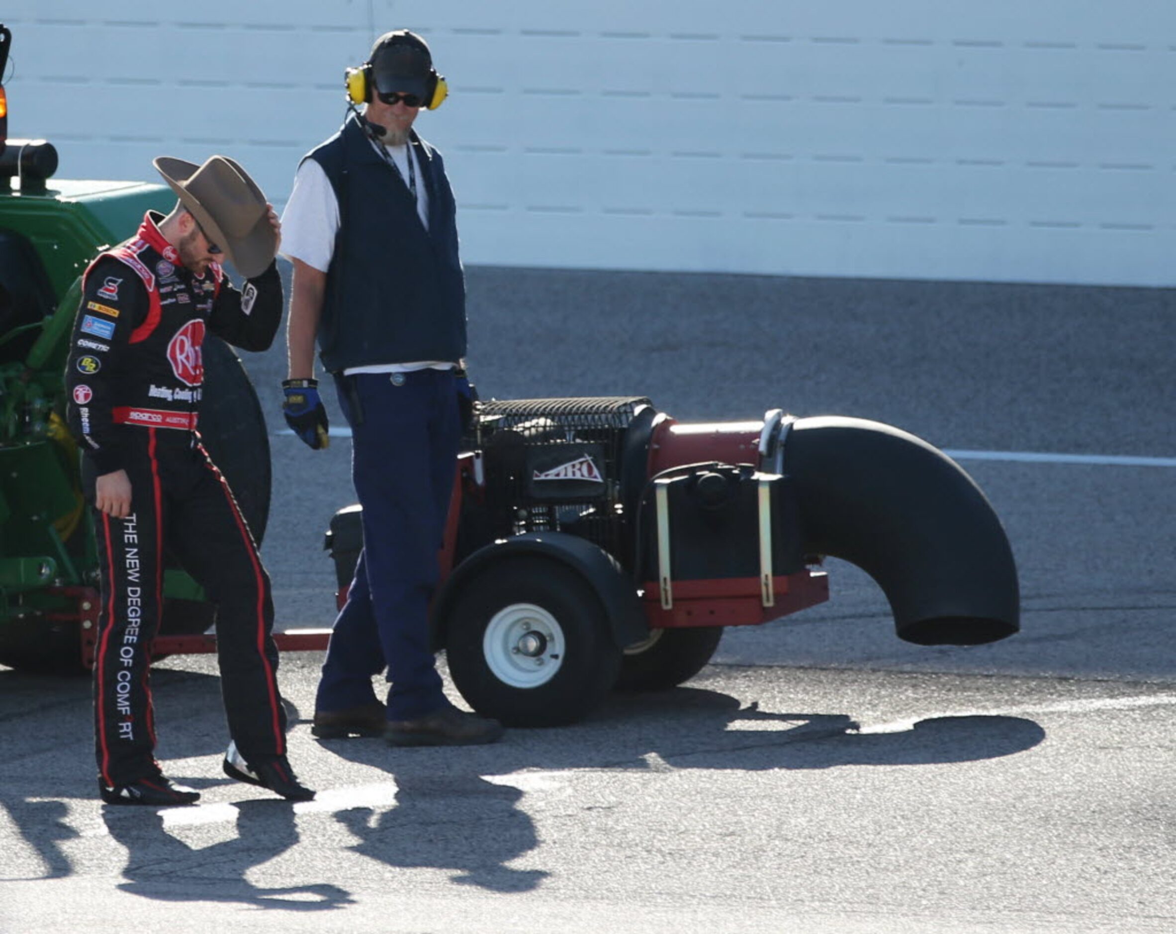 Austin Dillon (33) taps a wet area as a blower is used to dry the track shortly before the...