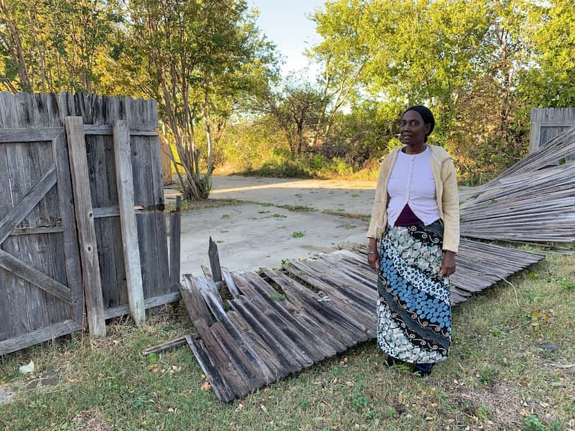 Mary Francis stands in front of a collapsed fence on October 21, 2019, in her backyard. She...