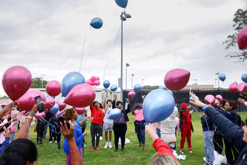 A balloon release for Janeecia “Nene” Mason was held by the softball field at Trinity High...