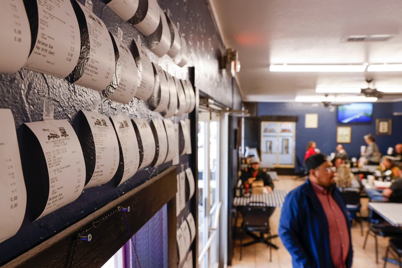 Receipts hang on the wall of Nearly Famous Burgers and Hotdogs on Dec. 13 in Arlington....