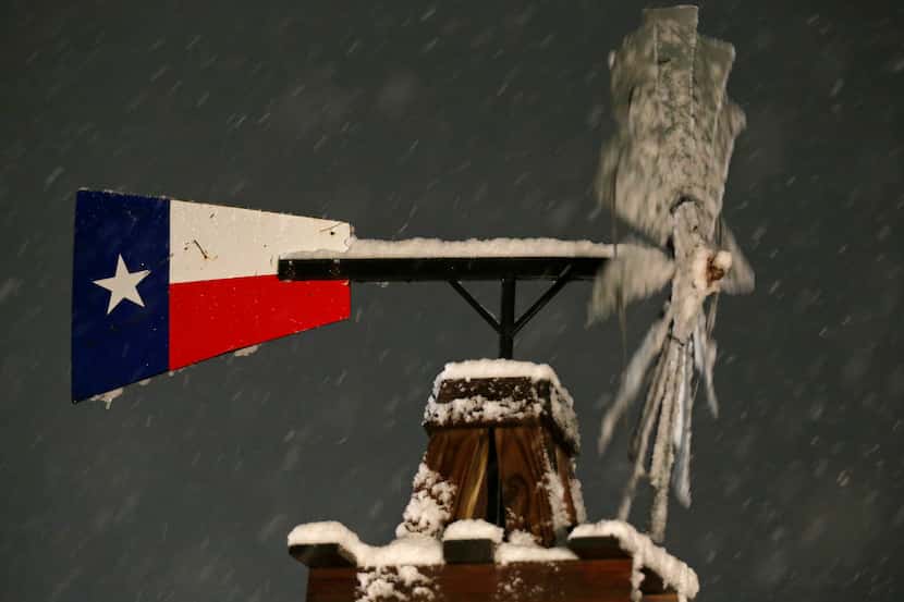 A windmill with snow Thursday Dec. 7, 2017 in Leon Springs, Texas. 