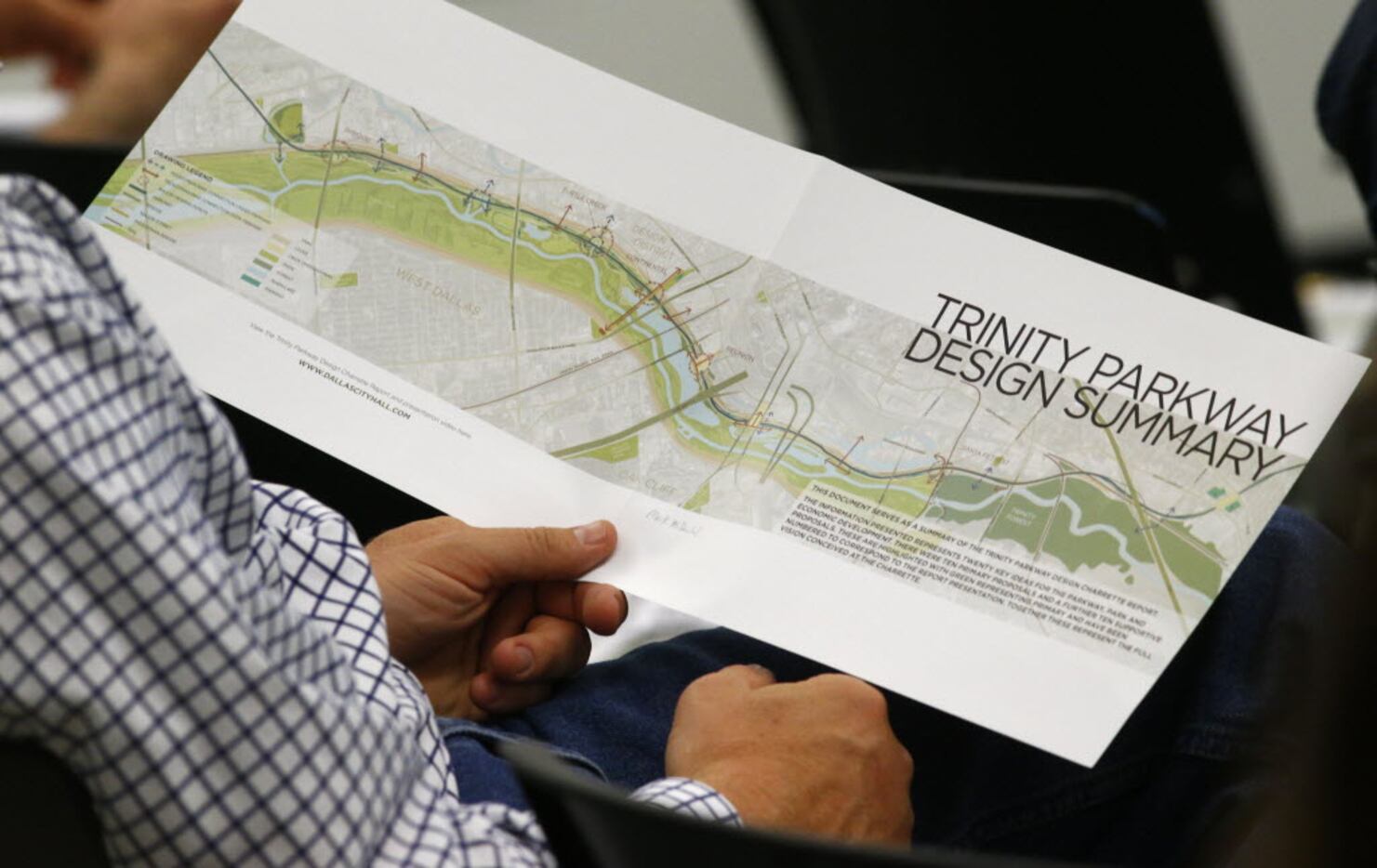 Bill Weinberg looks at a proposal from the Trinity Parkway team of urban experts during a...