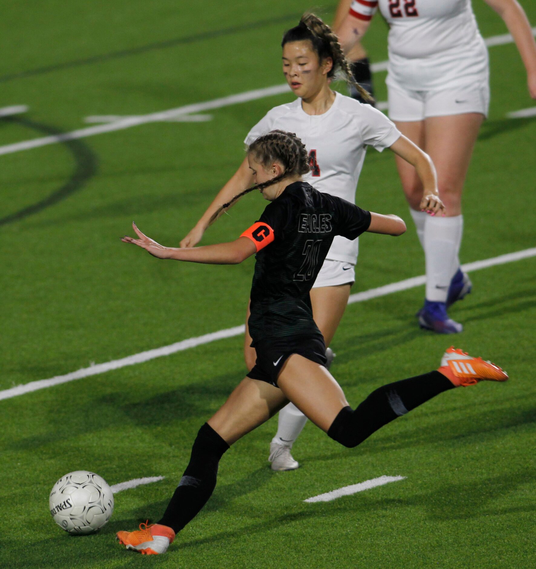 Prosper's Reaganne Crane (20) prepares to fire a shot on goal as Coppell's Michelle Pak (4)...