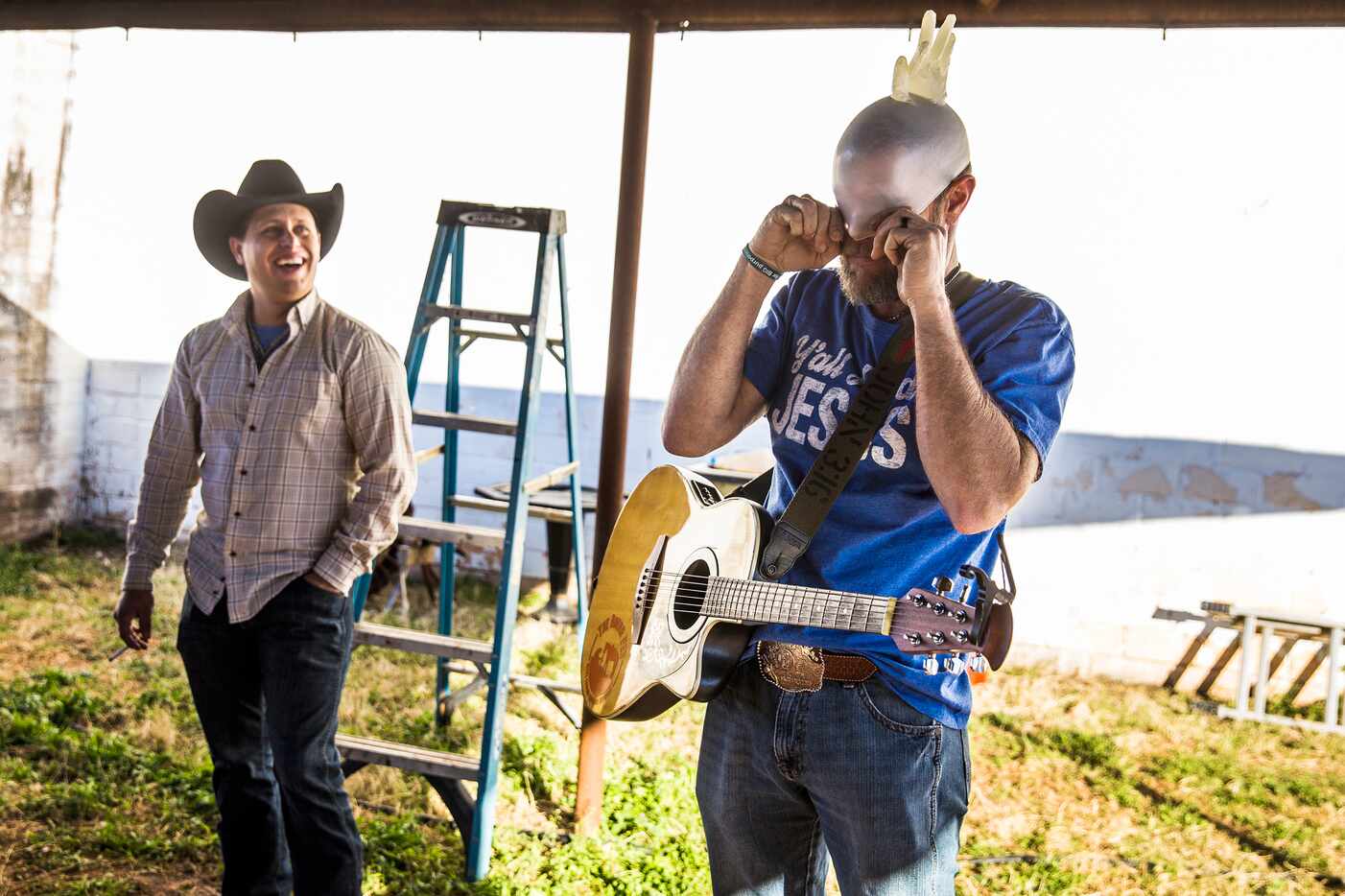 Congregation member Vincent Aguilera (left) laughs at youth pastor Beau Sessums as he puts a...