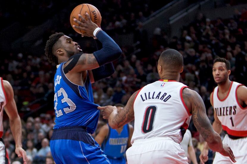 Dallas Mavericks guard Wesley Matthews, left, shoots over Portland Trail Blazers guard...