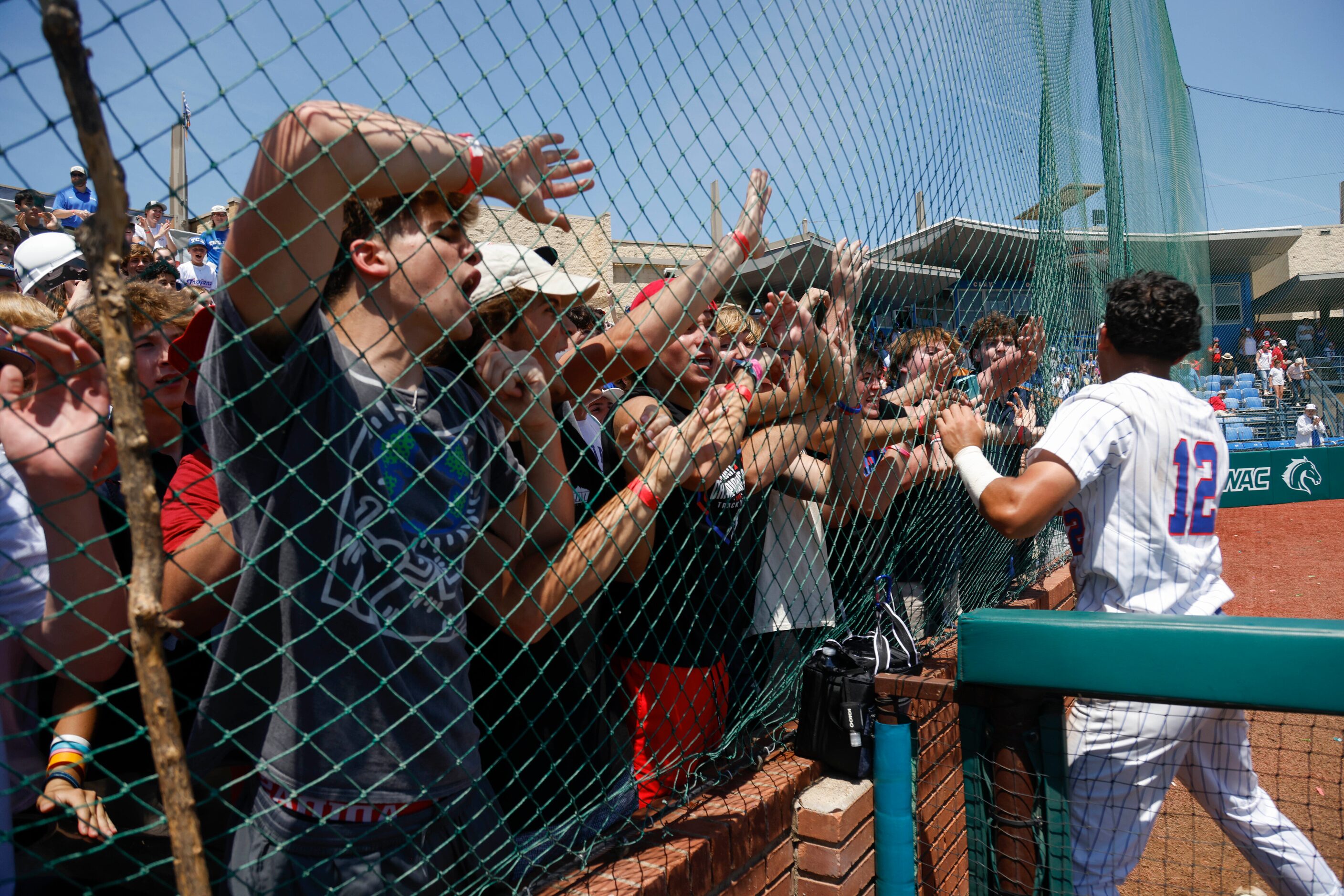 Trinity Christian’s Steven Ramos (12) runs to greet fans after defeating Houston St. Thomas,...