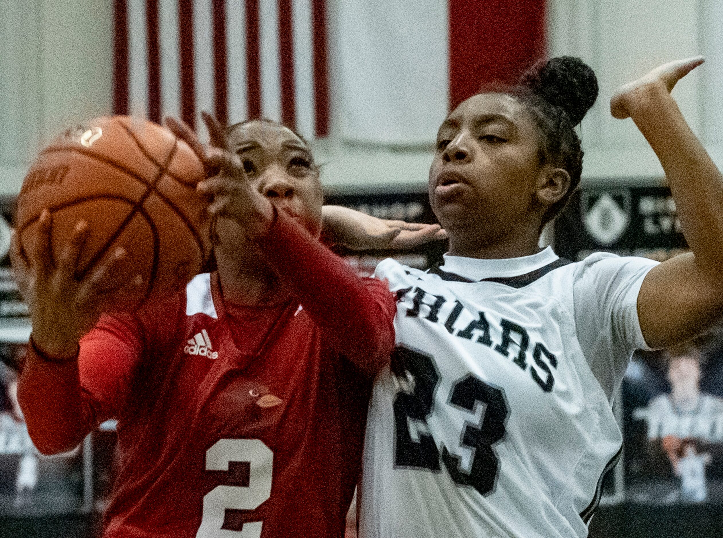 John Paul II High School Sydney Wade (2) holds the ball while Bishop Lynch High School Mikah...