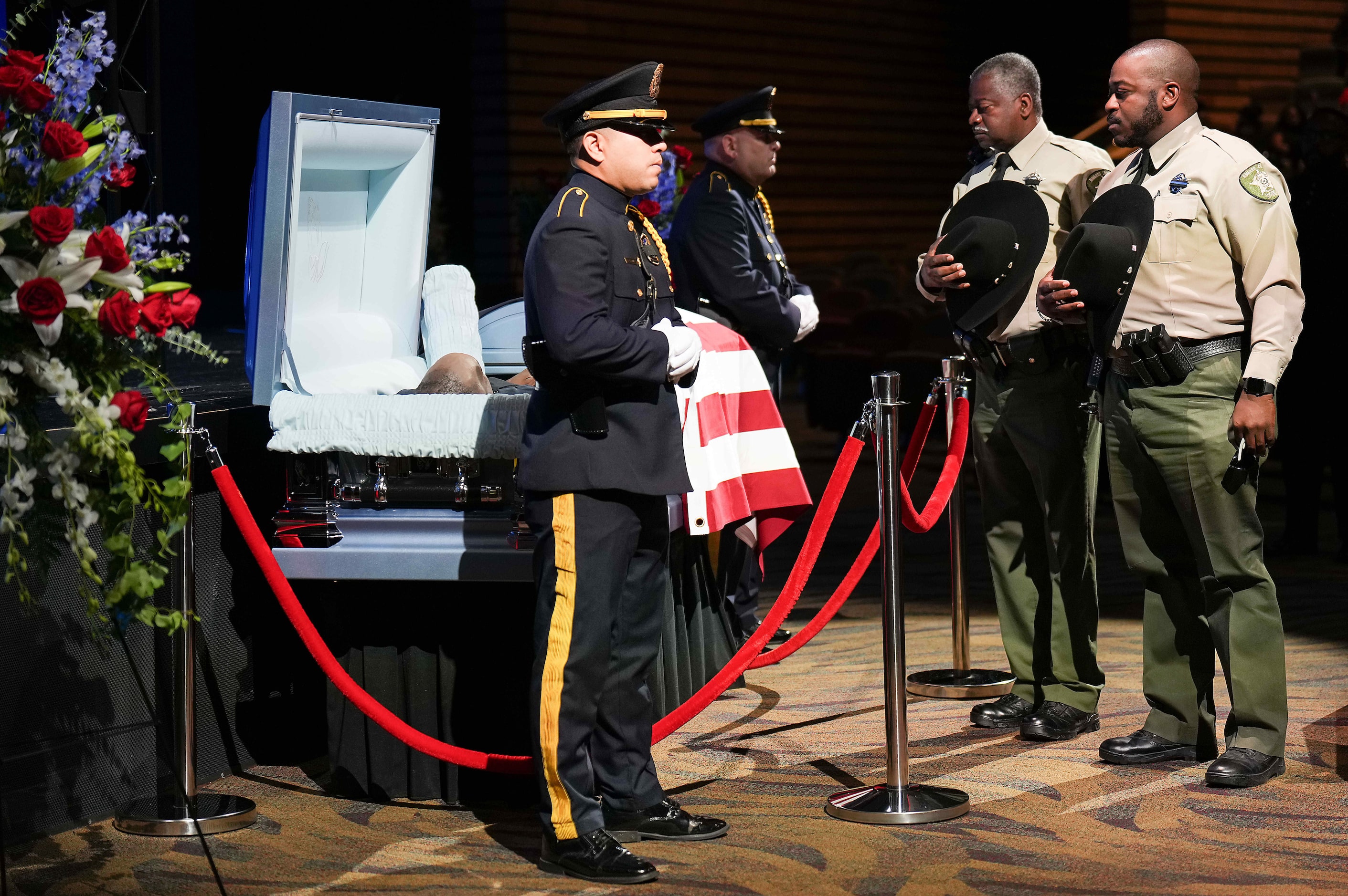 Navarro County Sheriffs Deputies pause at the casket of Dallas police officer Darron Burks...