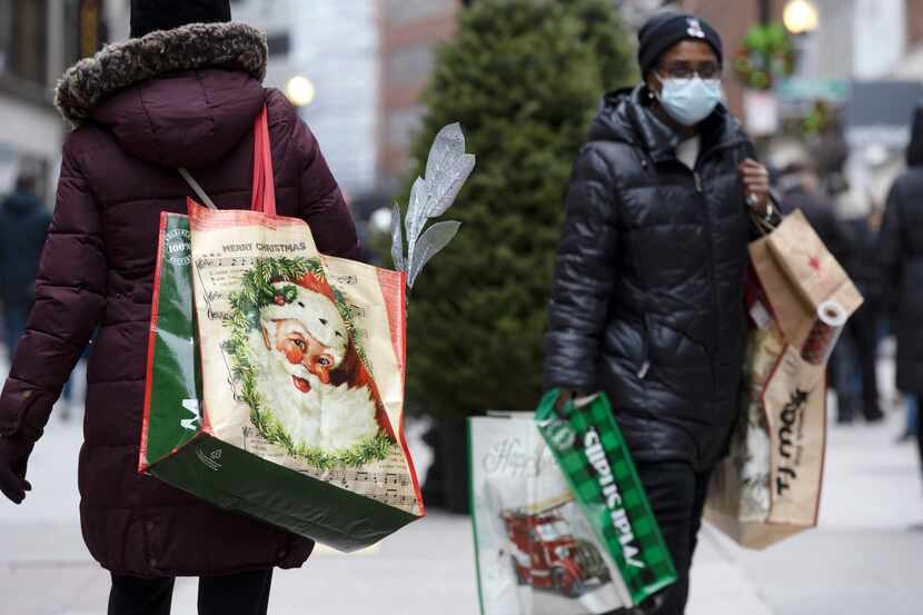 People carry shopping bags Dec. 10 at Downtown Crossing in Boston.