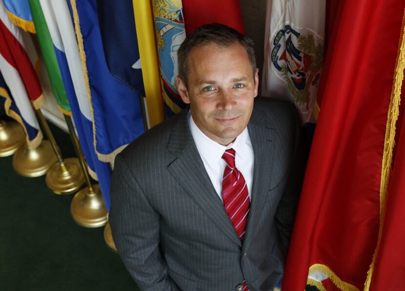 Dallas City Council member Mark Clayton of District 9, has his portrait taken in the flag...