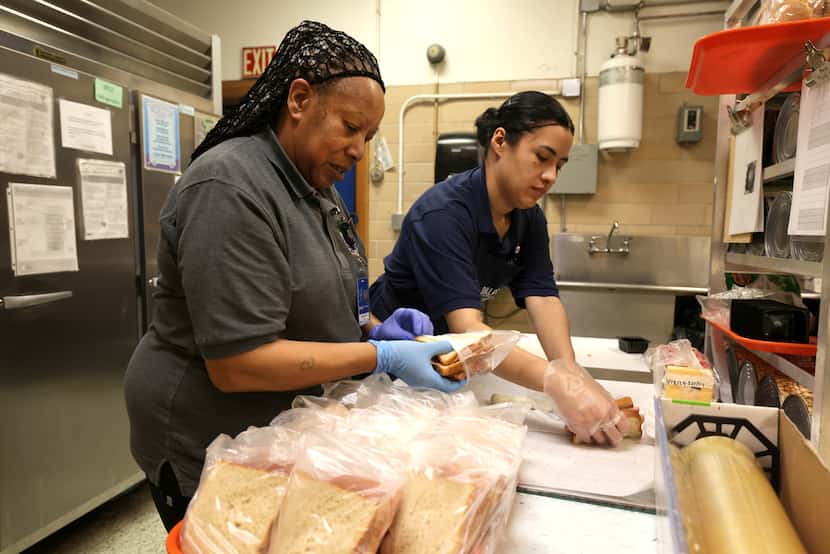 Jacquelyn Grant, left, and Maria Vazquez prepare lunches at Mockingbird Elementary School in...