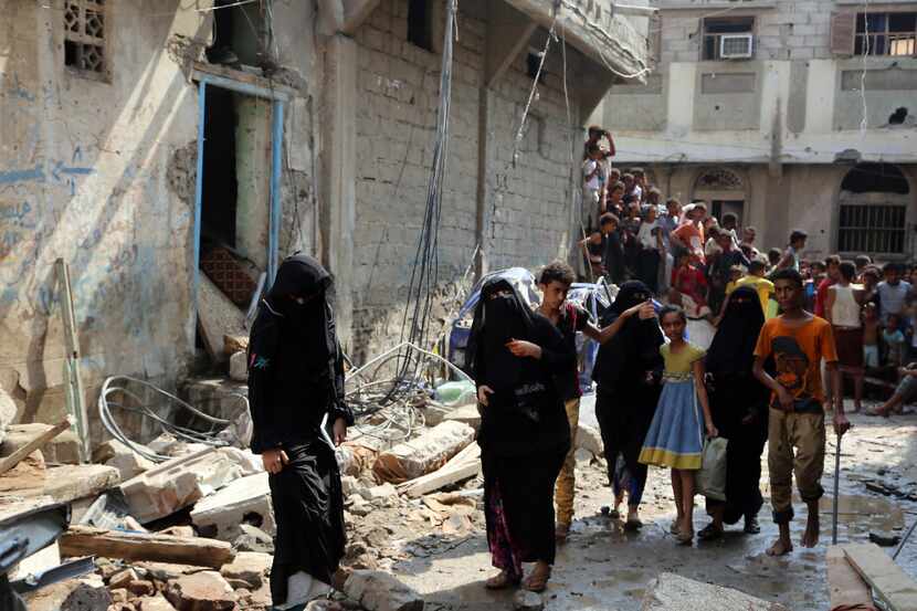 Yemenis walked amid the rubble of buildings destroyed last week during Saudi-led airstrikes...