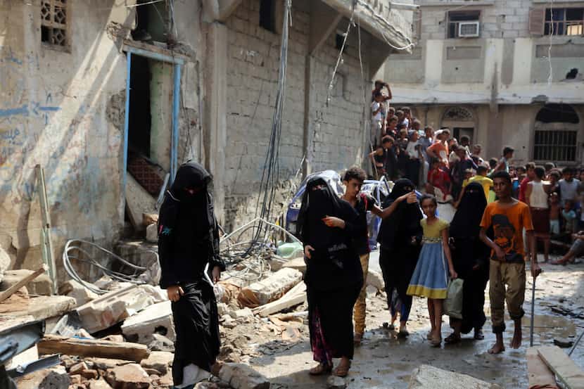 Yemenis walked amid the rubble of buildings destroyed last week during Saudi-led airstrikes...