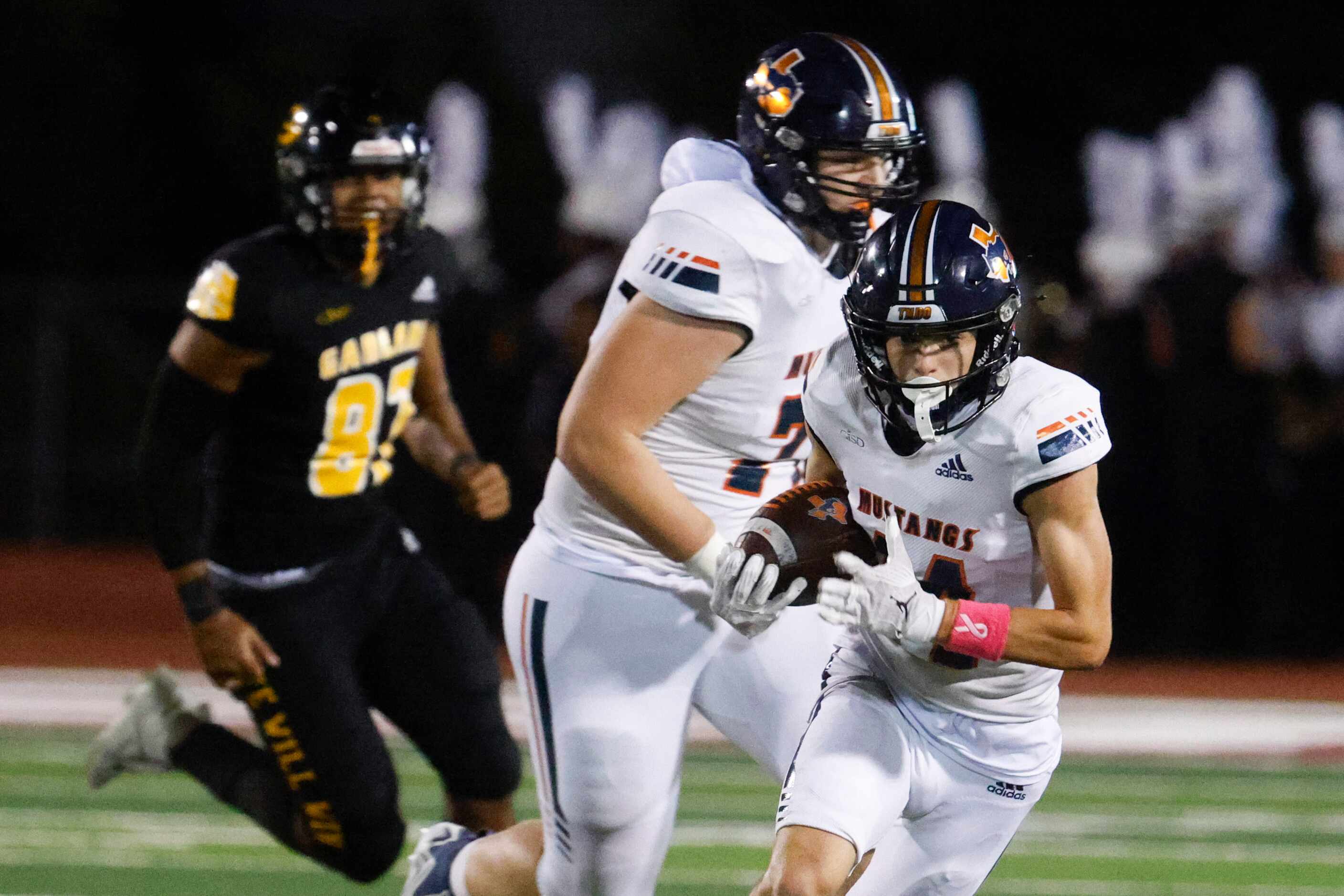 Sachse high school’s Robbie Rothrock (front) runs for a yardage against Garland High school...