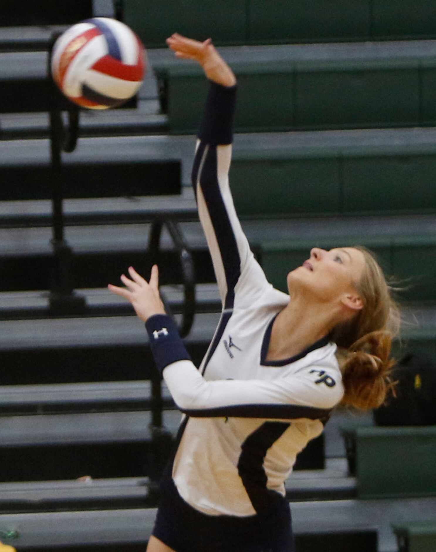 Highland Park outside hitter Kate Nugent (2) powers a spike for a winner during the first...