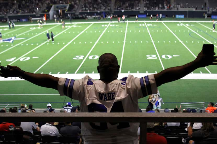 Dallas Cowboys fan Darrell Glenn takes in the team's final public practice of training camp....