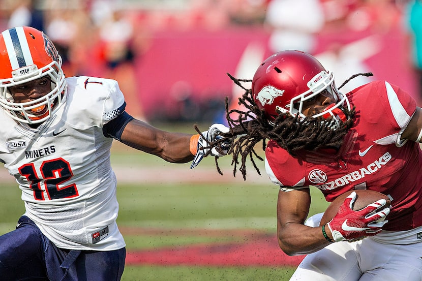 FAYETTEVILLE, AR - SEPTEMBER 5:  Keon Hatcher #4 of the Arkansas Razorbacks is tackled by...