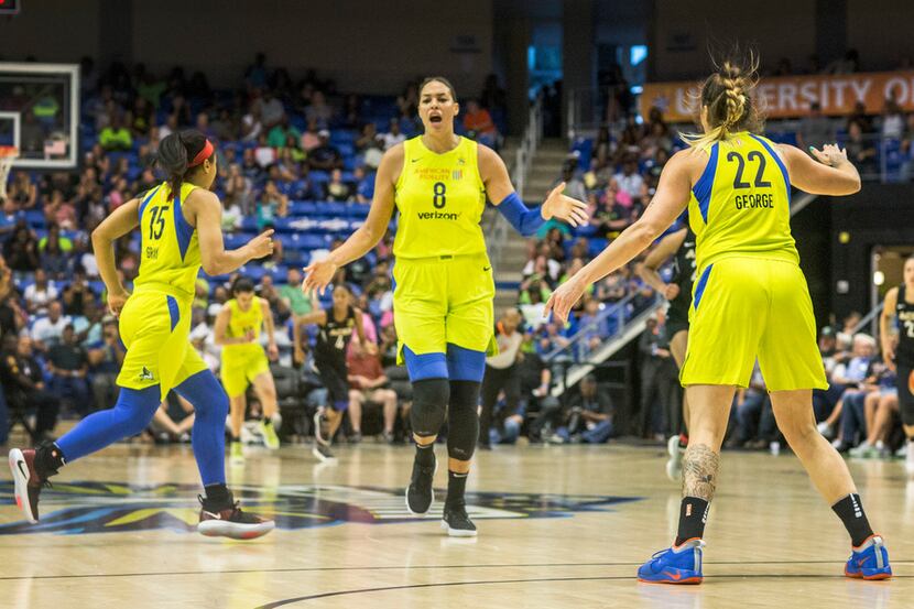 Dallas Wings players Allisha Gray (15), Liz Cambage (8) and Cayla George (22) react to a...