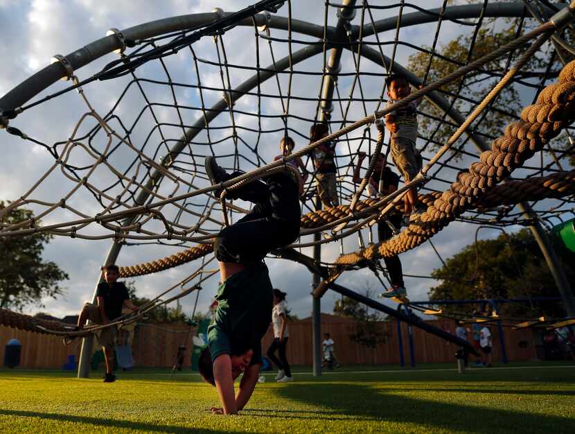 Children play on the equipment at Jubilee Park and Community Center in Dallas.