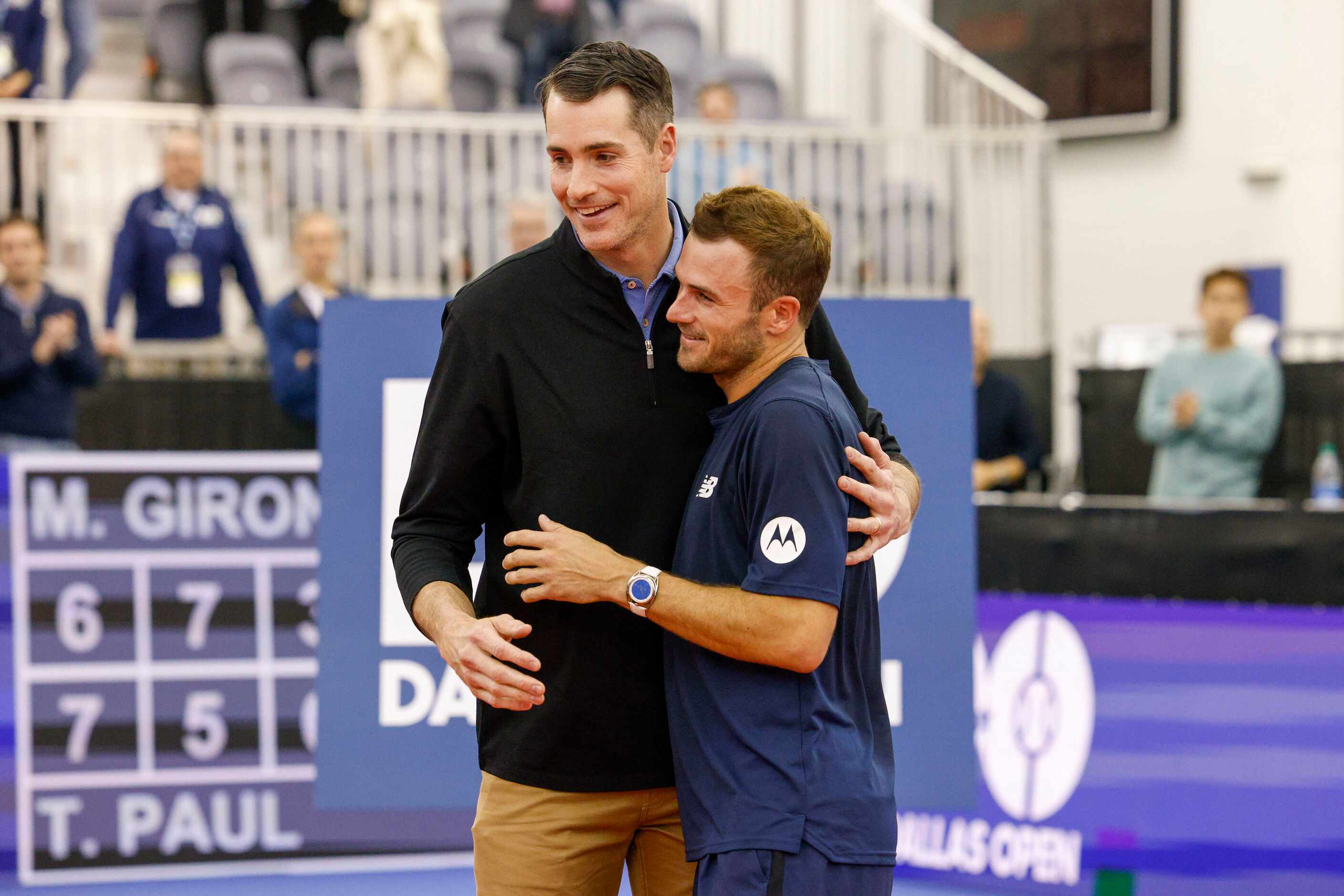 Former professional tennis player Jon Isner (left) embraces Tommy Paul of the U.S. as he...