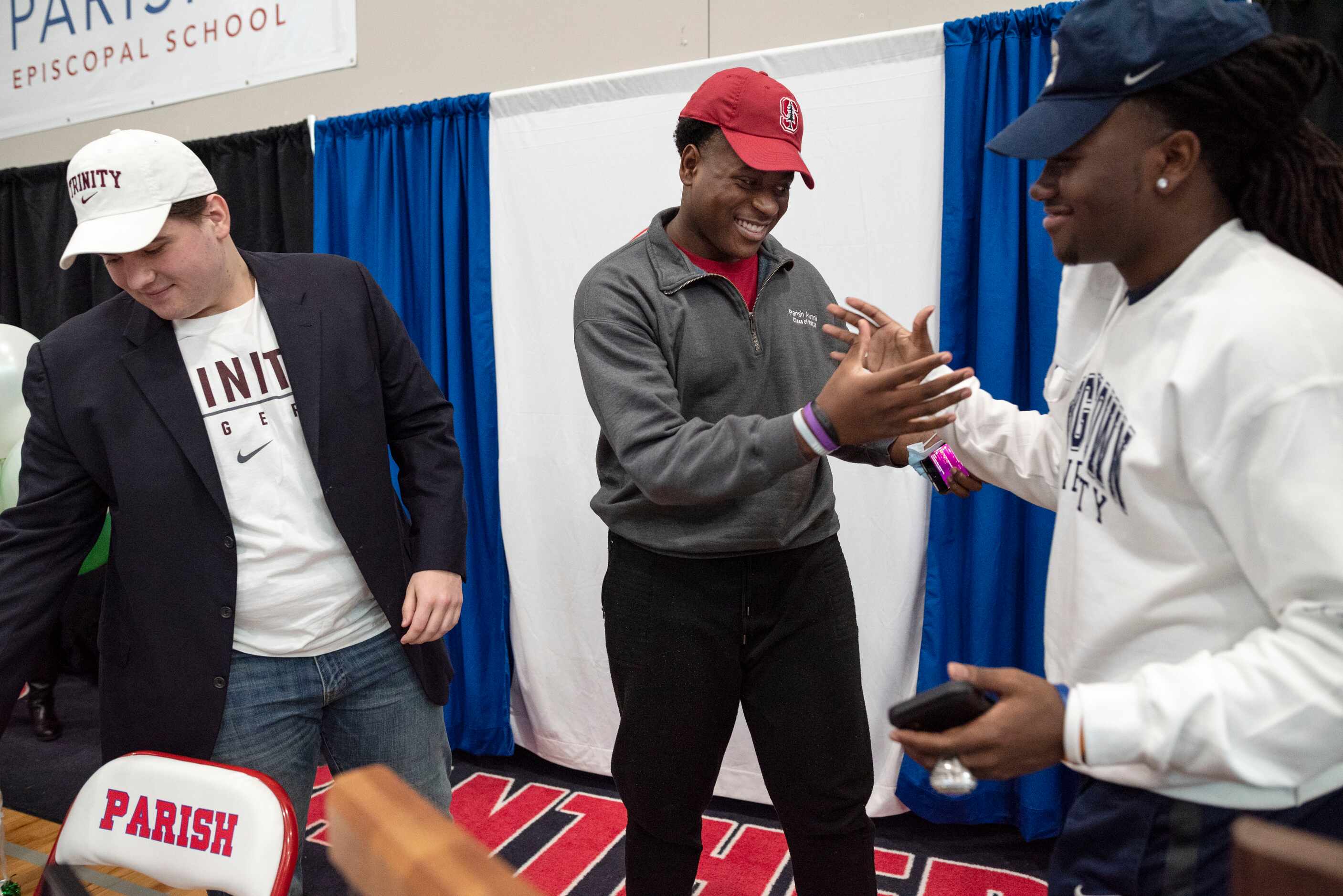 Parish Episcopal senior Austin Uke, center, is congratulated by teammates Joseph Mehary,...