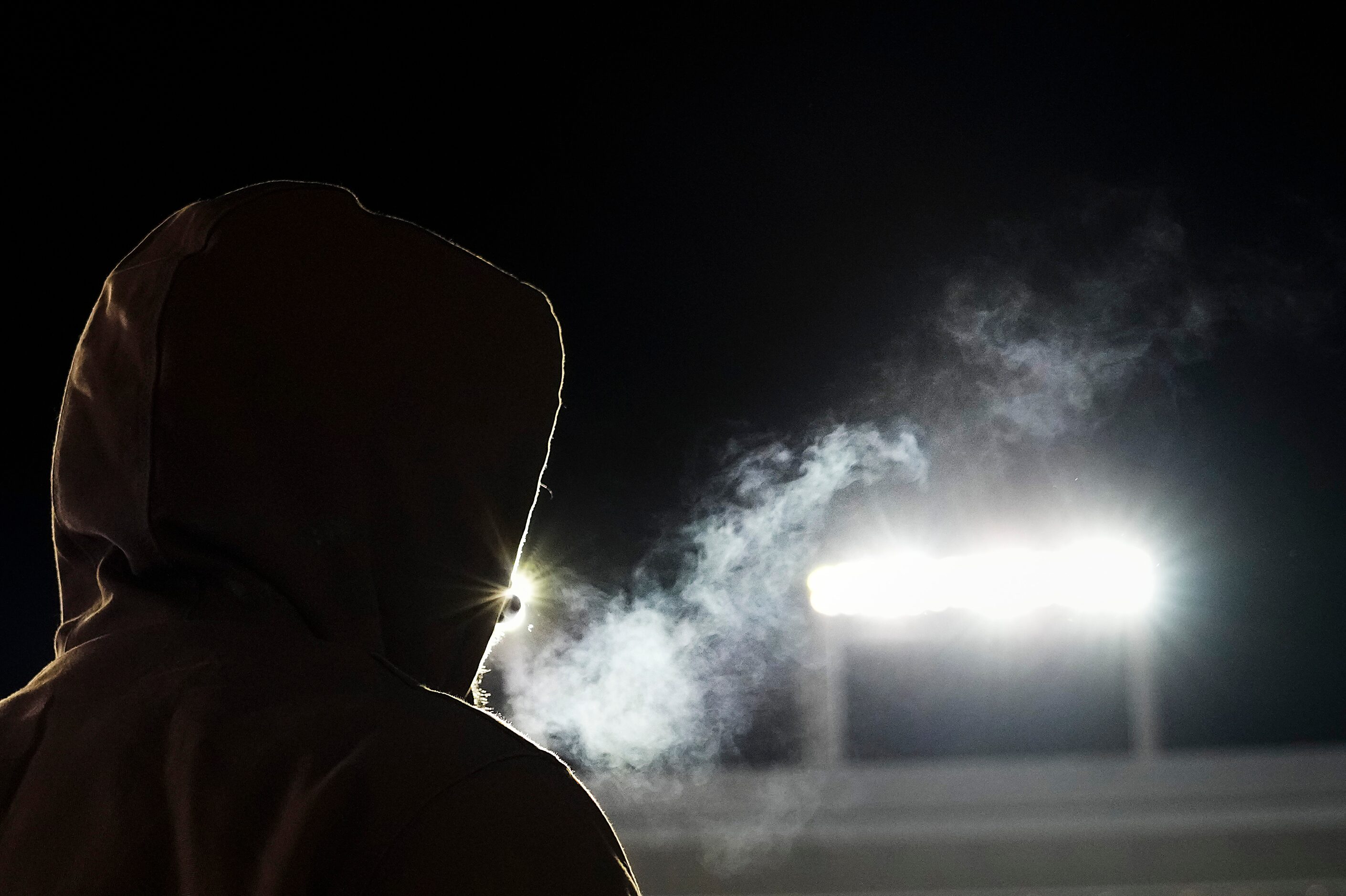 Fans bundle up against cold temperatures during the first half of the Armed Forces Bowl NCAA...