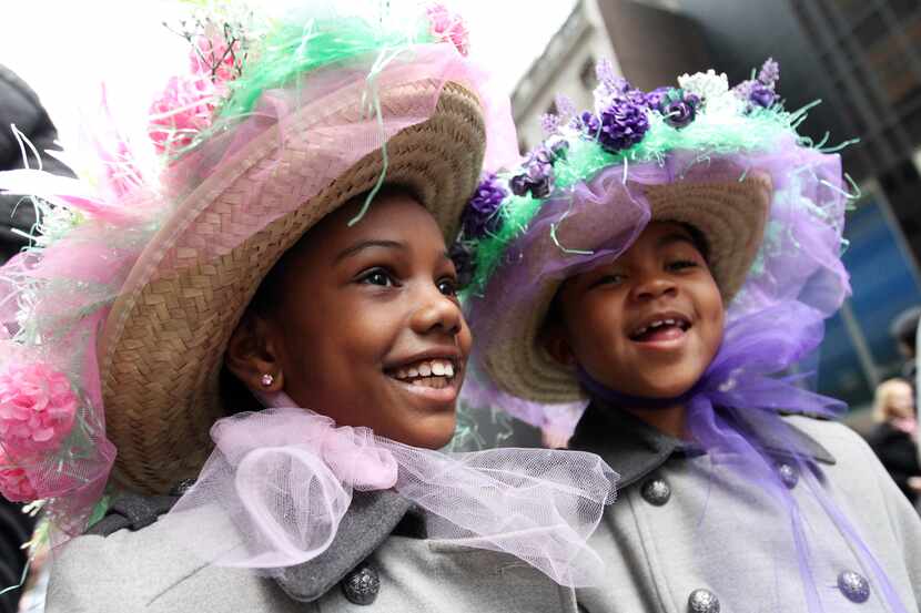 Sasha Bryant, left, and her sister India Bryant walk in the Easter Parade along New York's...