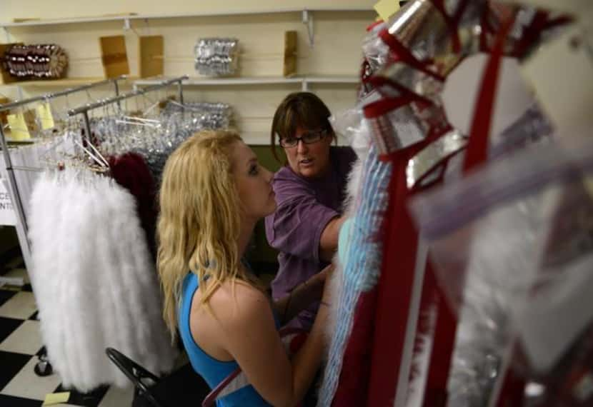 Michelle Mendoza  (right), a member of the Planoette Mum Moms at Plano Senior High School,...