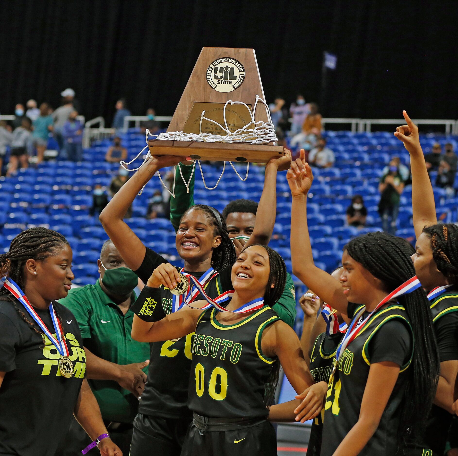 DeSoto Ayanna Thompson #20 holds up their trophy. DeSoto vs. Cypress Creek girls basketball...