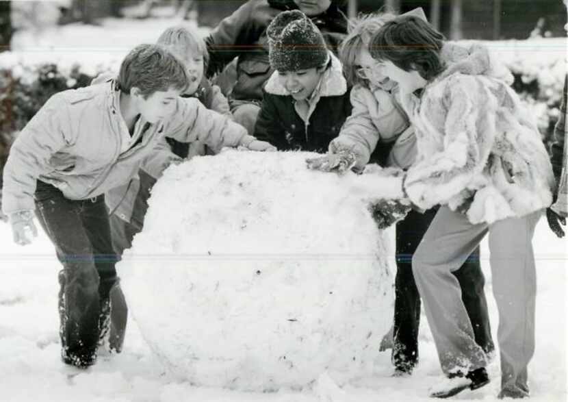 A photo published on Dec. 16, 1983, of Dallas fifth graders making a snowman during an...