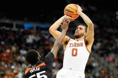 Texas forward Timmy Allen shoots over Miami guard Wooga Poplar in the second half of an...