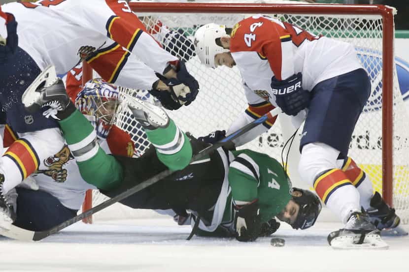 Dallas Stars left wing Jamie Benn (14) is knocked to the ice by Florida Panthers defensemen...