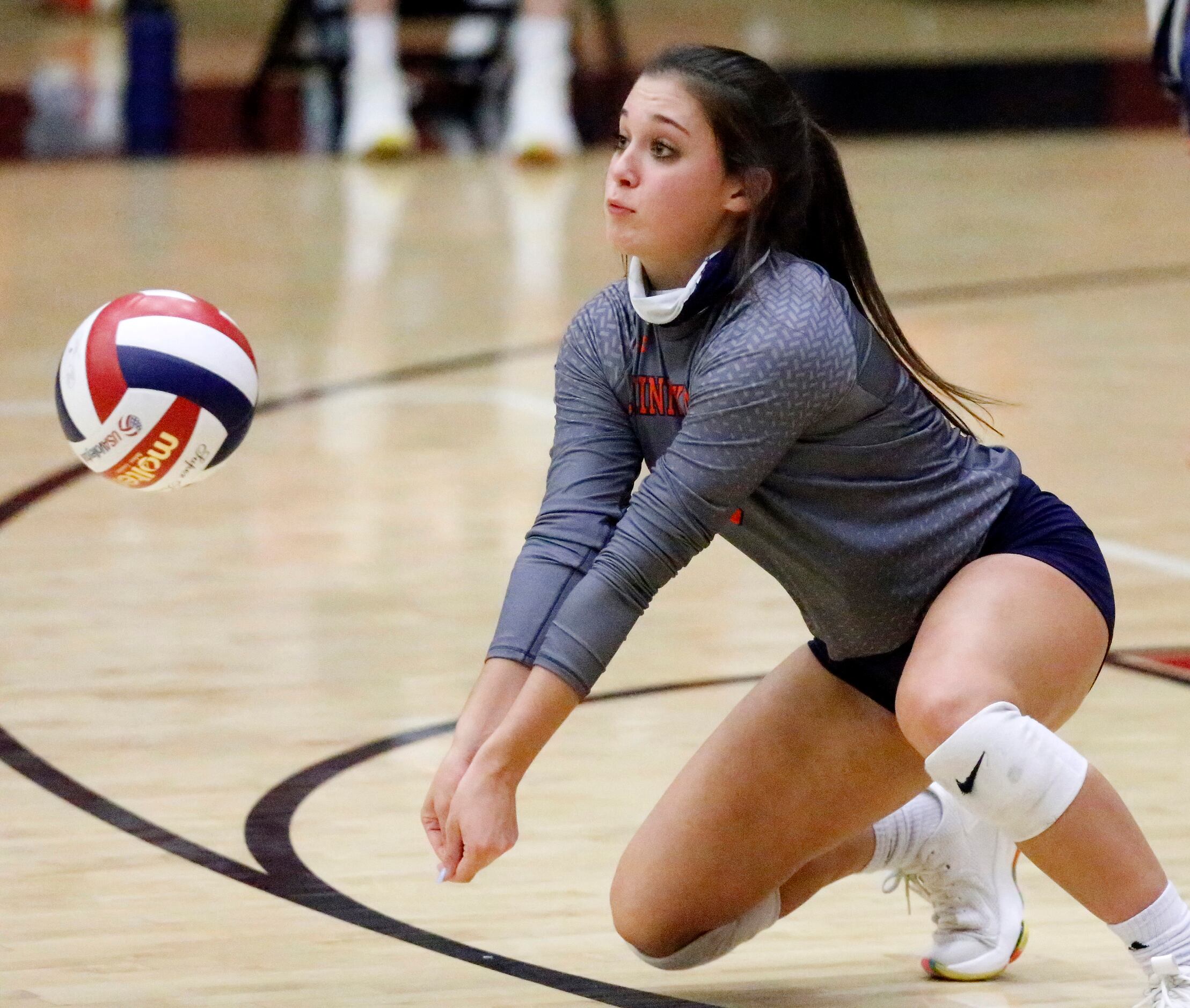 McKinney North High School libero Tinley Merder (8) receives a serve during game one as...