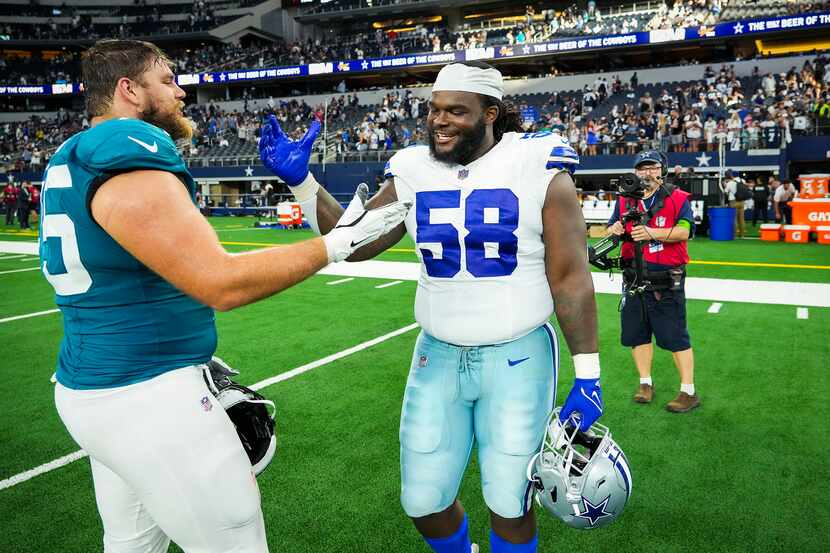 Dallas Cowboys defensive tackle Mazi Smith (58) shakes hands with Jacksonville Jaguars...