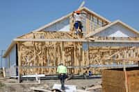 Construction workers frame new houses in Eastland new home community, Tuesday, May 14, 2024,...