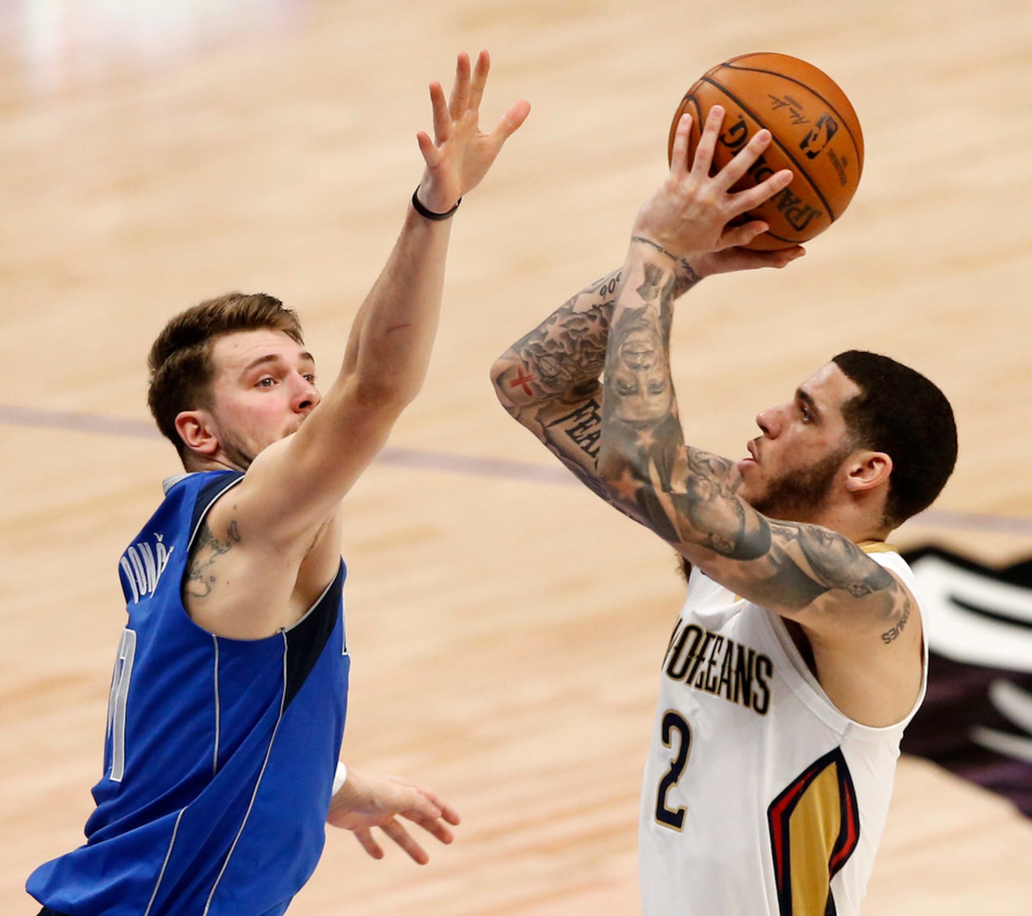 New Orleans Pelicans guard Lonzo Ball (2) shoots over Dallas Mavericks guard Luka Doncic...