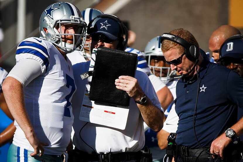 Dallas Cowboys quarterback Cooper Rush (7) gets instruction from offensive coordinator Scott...