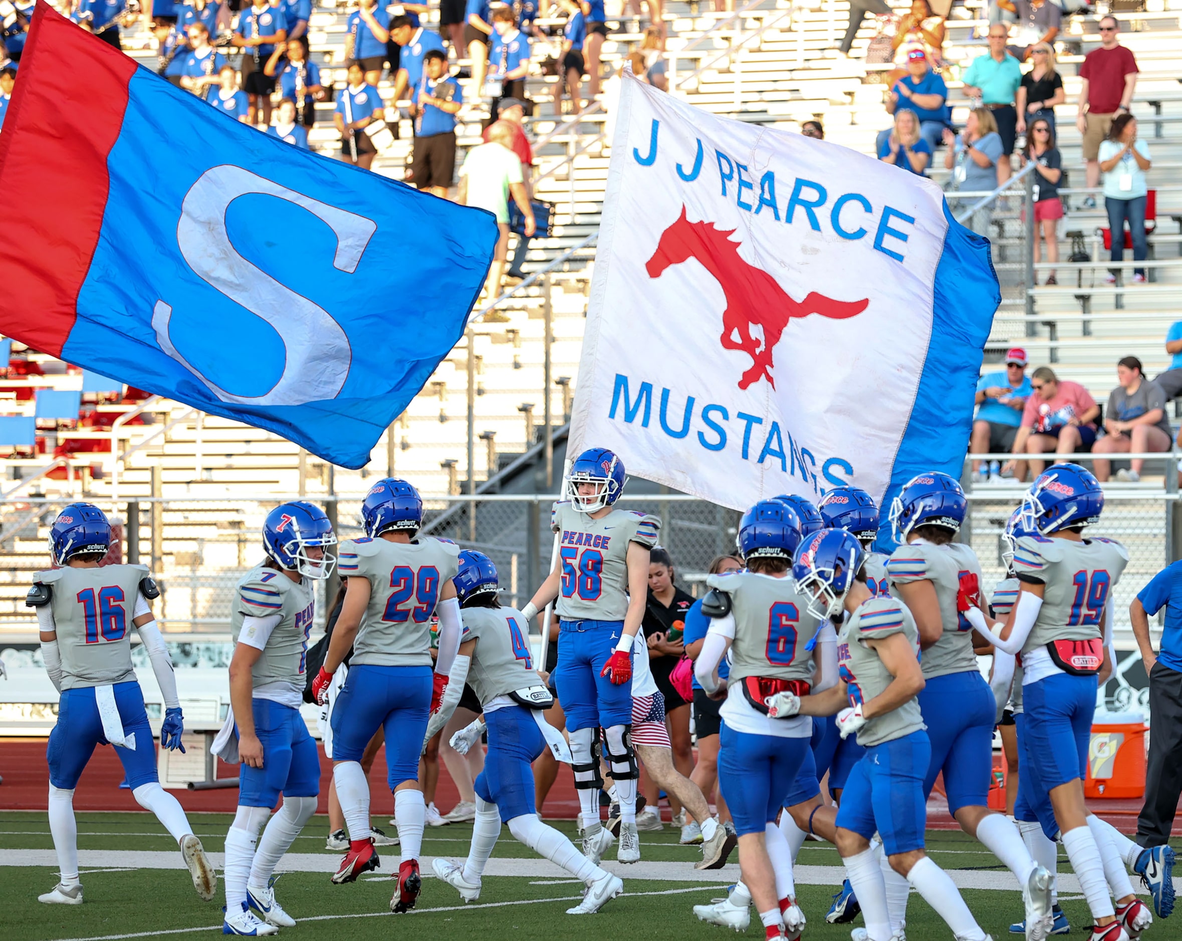 The Richardson Pearce Mustangs enter the field to face Flower Mound Marcus in a nondistrict...