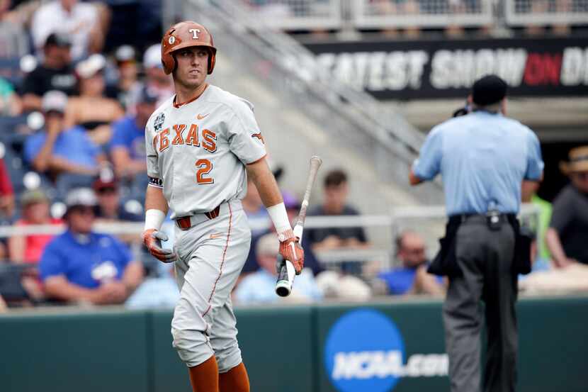 Texas' Kody Clemens (2) walks to the dugout after striking out in the first inning of an...