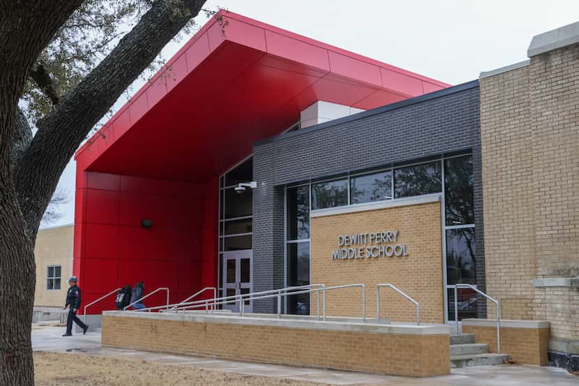 People enter and exit Carrollton-Farmers Branch ISD’s DeWitt Perry Middle School in...