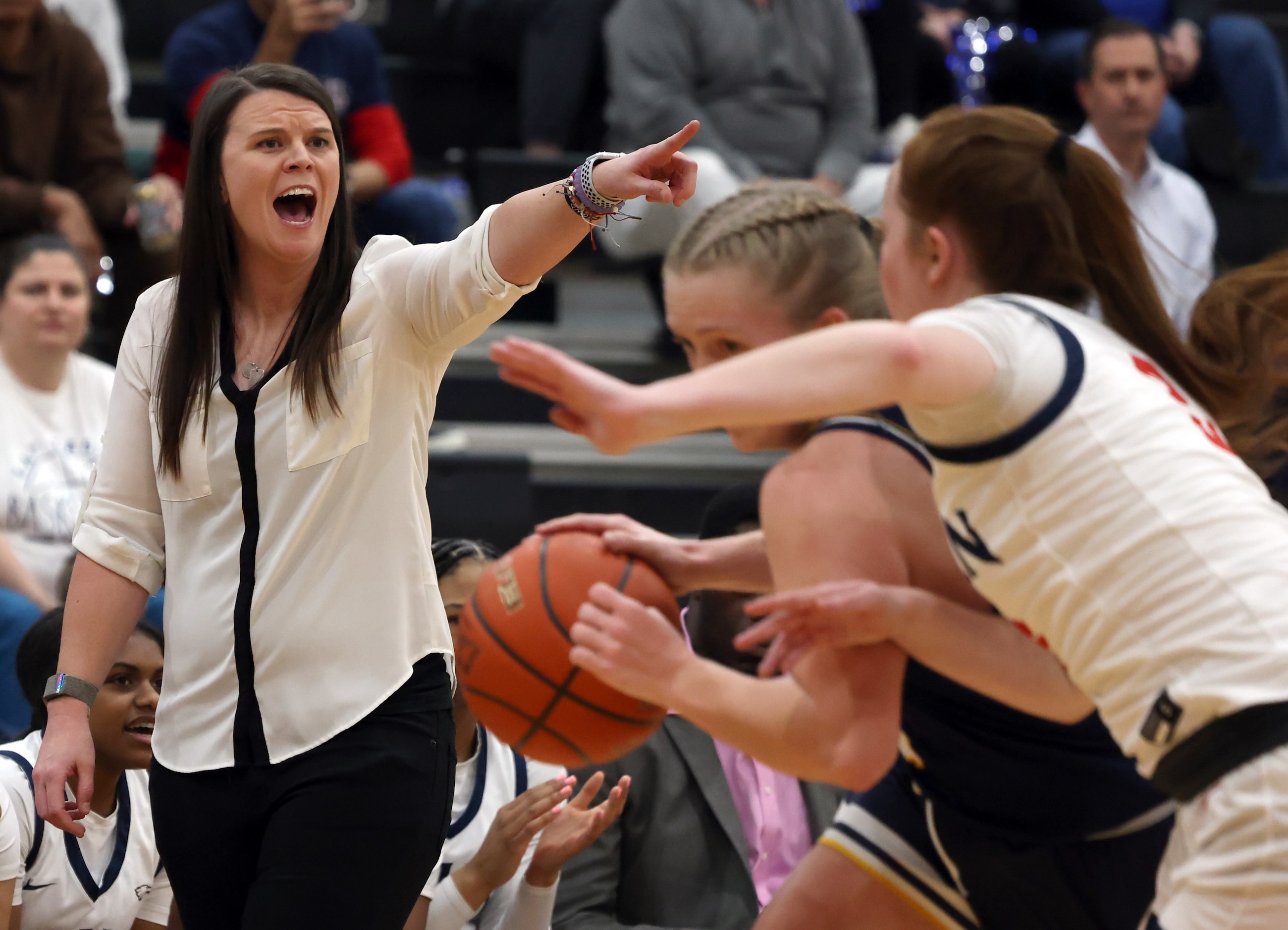 Allen head coach Stephanie Shaw directs her players from the team bench area during the...