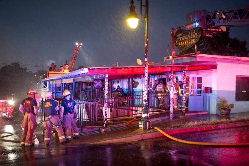 Firefighters work at a fire at Franklin Barbecue in Austin, Texas, on Saturday, Aug. 26,...