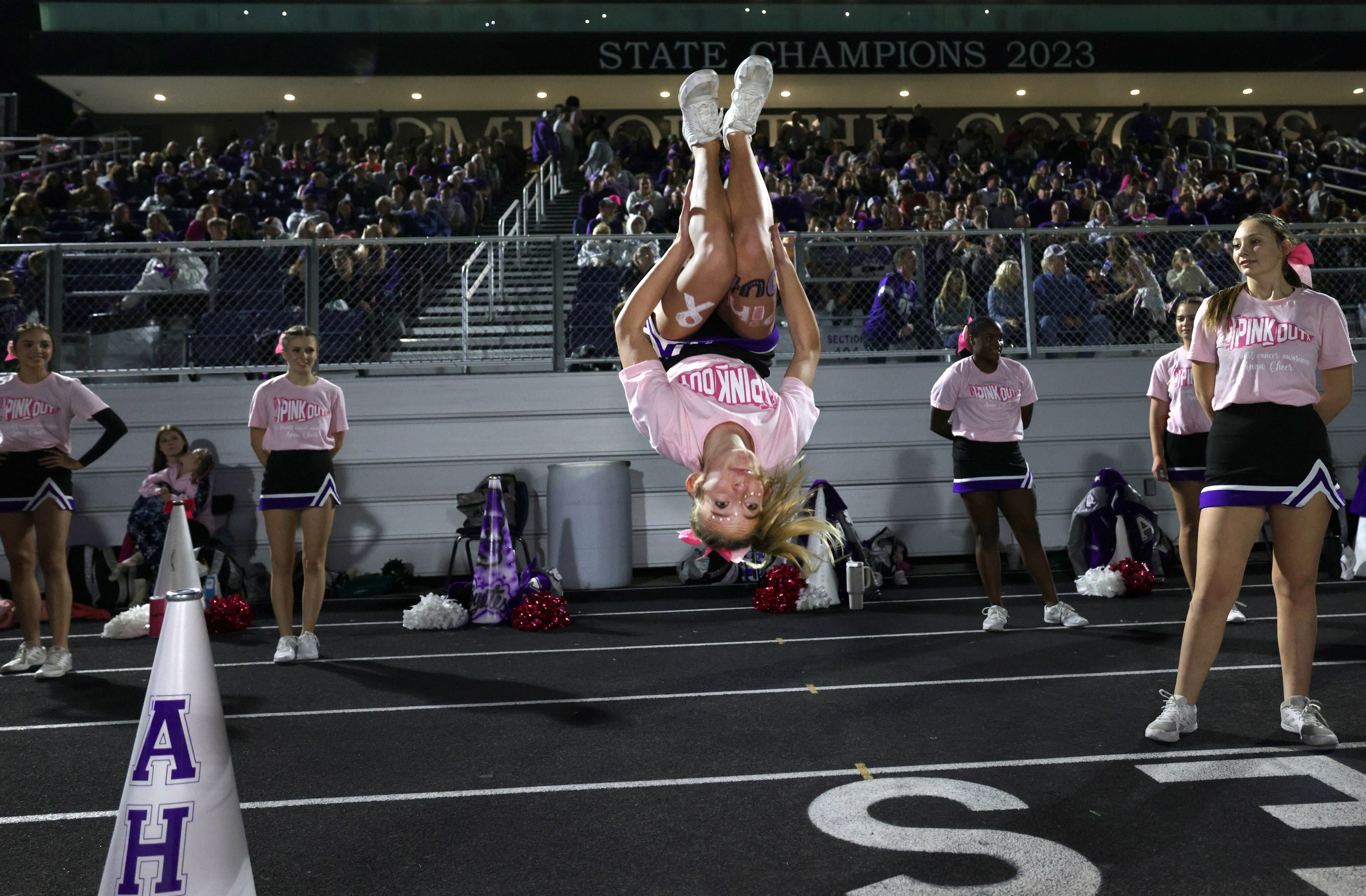 Anna cheerleader Isabella Gilmore does a backflip during the Prosper Walnut Grove High...