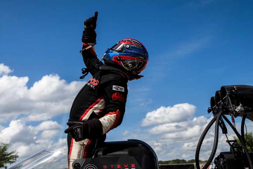 Steve Torrence celebrates after advancing to the final in the top fuel race during the AAA...