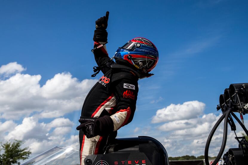 Steve Torrence celebrates after advancing to the final in the top fuel race during the AAA...
